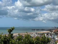 Looking back across Hastings Pier, towards Eastbourne and Beachy Head in the distance